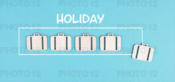 Progress bar with suitcases, holiday loading ist standing on the paper, planning a trip for the