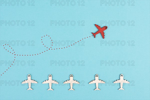 Red airplanes takes a different direction, leadership and business concept, follow your dreams,