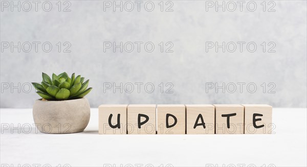 The words update is standing on wooden cubes, progress in business, desk in an office, copy space