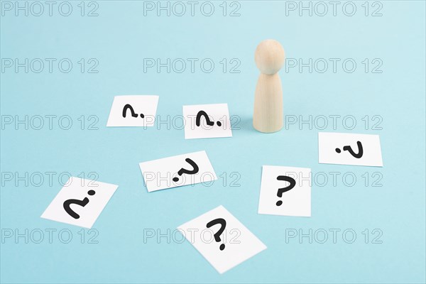 Man is thinking, question marks, brainstorming and looking for answers, solving a problem, making a