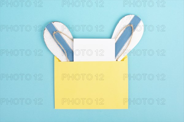 Blue colored summer and vacation background, flip flops in an envelope, copy space for text,