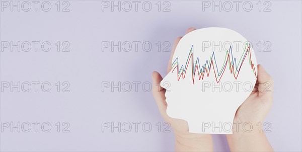 Holding a head in the hands, epilepsy disorder awareness, brain waves, mental health care, paper