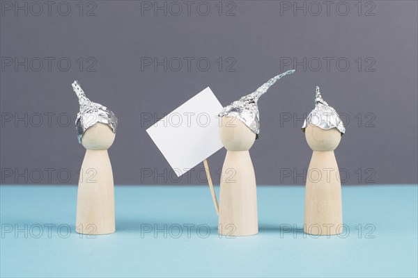 Group with alu hats protesters talking together, conspiracy theories, tin foil on the head, holding
