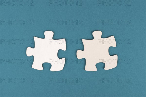Two pieces of a puzzle, connecting together as a team, solving a problem, strategy and