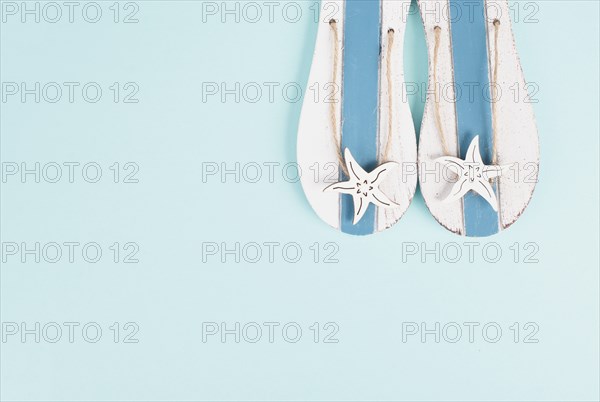 Blue colored summer and vacation background, slippers with sea stars, copy space for text, holiday