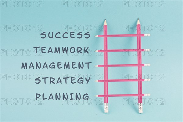 Ladder of success build with pencils, planning a strategy, teamwork for success step by step