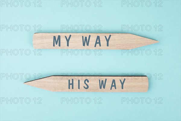 The words my way his way are standing on wooden arrows, christian religion faith, trust and believe