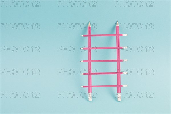 Ladder of success build with pencils, opportunity strategy, blue background, copy space for text,