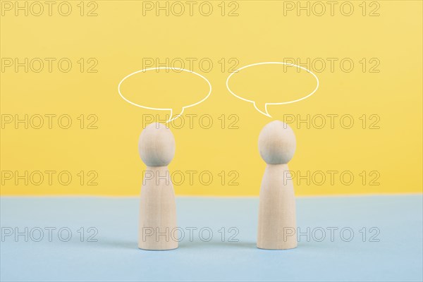Two people talking together, empty speech bubbles, having a conversation, networking and teamwork