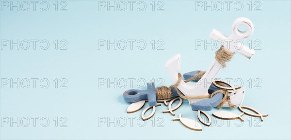 White anchor and fish on a blue background, maritime sea life, sailing trip, summer vacation,