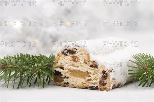 Christstollen, traditonal christmas cake with nuts, raisons, marzipan on a blue background, empty