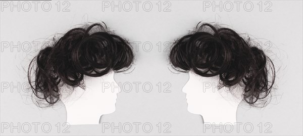 Silhouette of two faces with hair looking to each other, communication, having an opinion and
