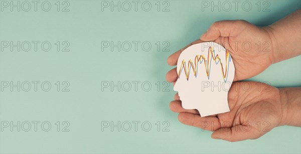 Holding a head in the hands, mental health concept, alzheimer and epilepsy disorder, brain waves,