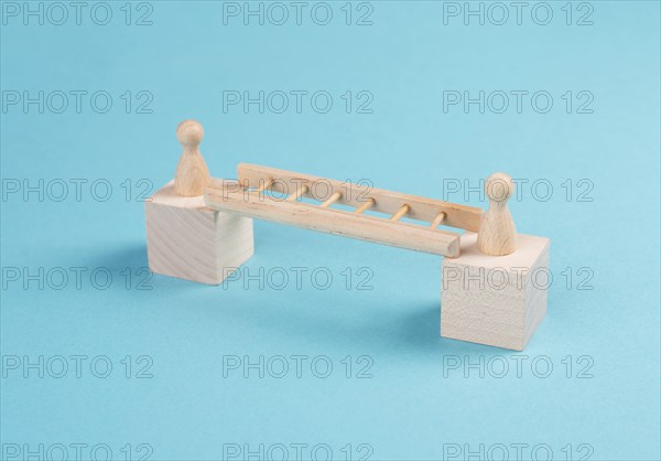 Two people connect by a ladder, buliding a bridge between men, separation and connection concept,