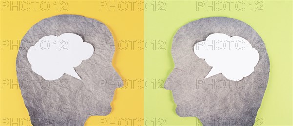Silhouette of two faces, speech bubble in white color, copy space for text, communication, having