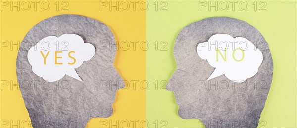 Head silhouettes with speech bubbles, words yes and no, communication between people, business and