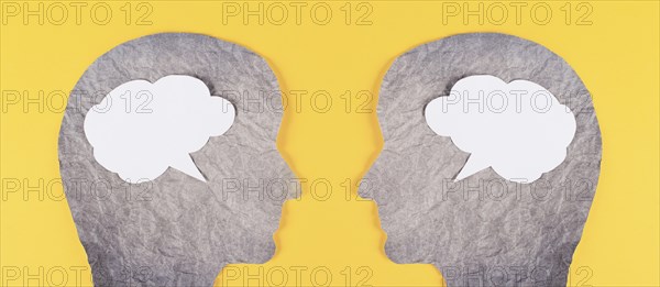 Silhouette of two faces, speech bubble in white color, copy space for text, communication, having