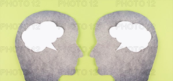 Silhouette of two faces, speech bubble in white color, copy space for text, communication, having