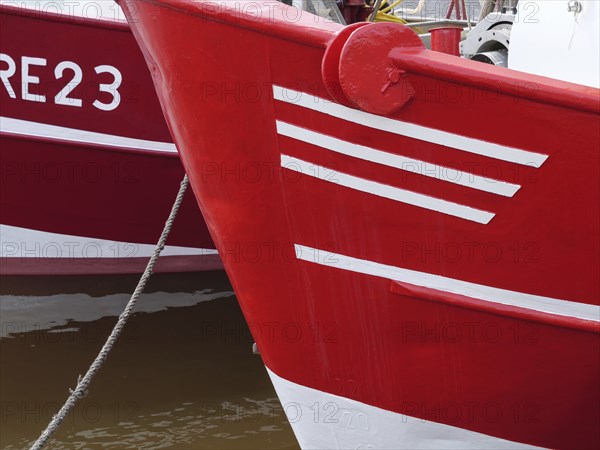 Close-up of two red fishing boats in the harbour, ready for action, greetsiel, east frisia, germany