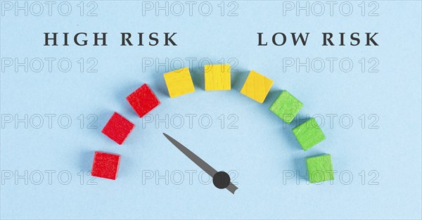 Tachometer high and low risk, pointer is showing to the red risky scale, financial credit and