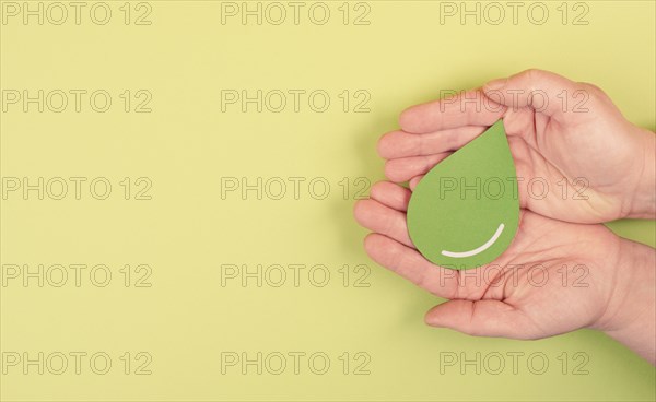 Holding a green drop, olive oil, alternative bio fuel, recycling resourses, sustainability