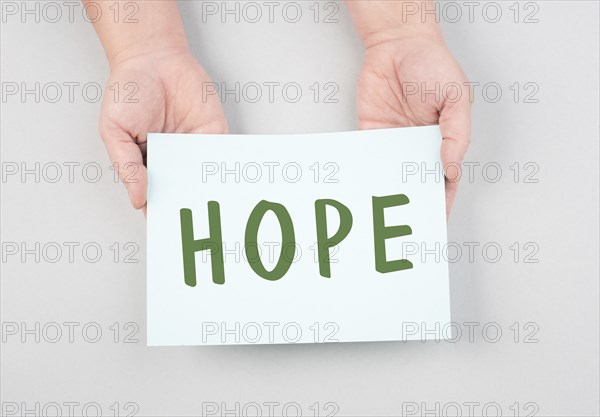 The word hope is standing on a paper, positive mindset, optimism for the future