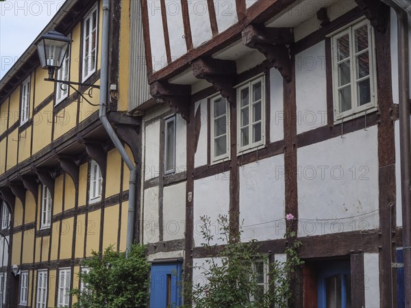Traditional half-timbered houses with a street lamp and flowers on the facades, Detmold, North