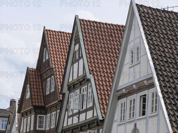 Gables of historic half-timbered houses with red and white roofs under a cloudy sky, Detmold, North