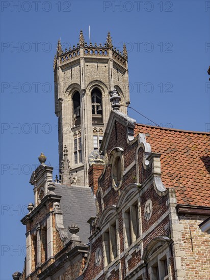 Gothic stone bell tower with ornate details on a sunny day, Bruges, Flanders, Belgium, Europe