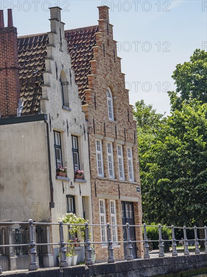 Historic brick houses with gables on a sunny day near a canal, Bruges, Flanders, Belgium, Europe