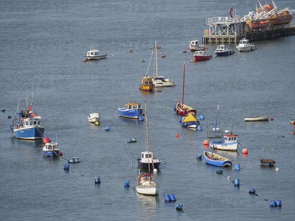 Several boats and moorings in the water with a calm clear sky in the background, newcastle upon