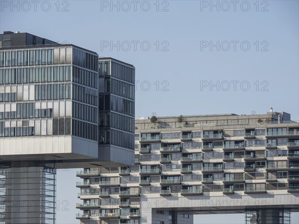 Modern high-rise buildings with glass facades in an urban environment under a clear sky, Cologne,