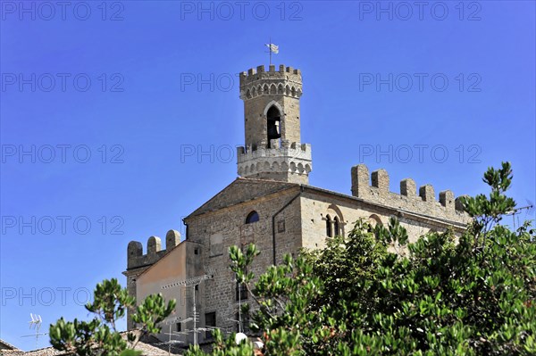 Volterra, Tuscany, Italy, Europe, A medieval castle with a high tower under a blue sky, surrounded