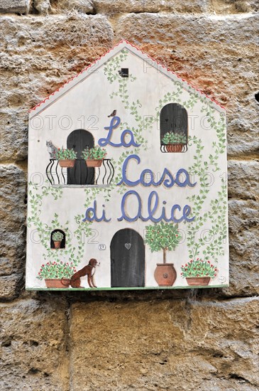 Volterra, Tuscany, Italy, Europe, Decorative hand-painted sign 'La Casa di Alice' on a stone wall