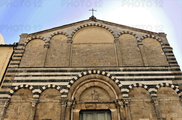 Volterra, Tuscany, Italy, Europe, Exterior view of a church with a stone faÃ§ade and a cross on