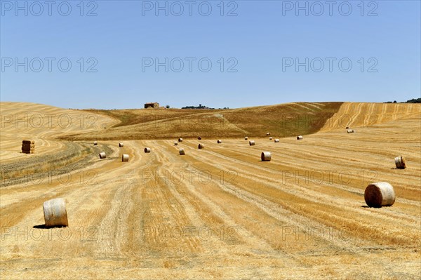 Harvested wheat fields, landscape south of Pienza, Tuscany, Italy, Europe, Several hay bales