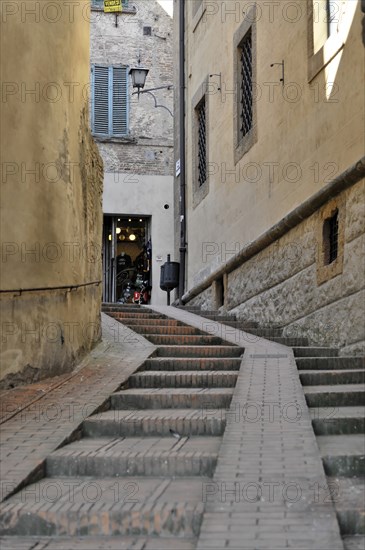 Volterra, Tuscany, Italy, Europe, A narrow alley in an old town centre leads up steps to an open