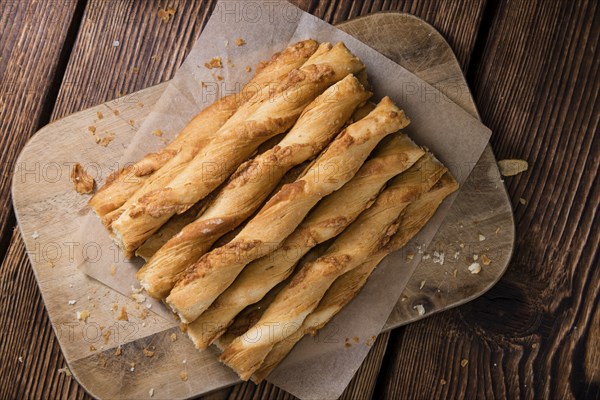 Crispy Pastry Sticks on wooden background (close up shot, selective focus)