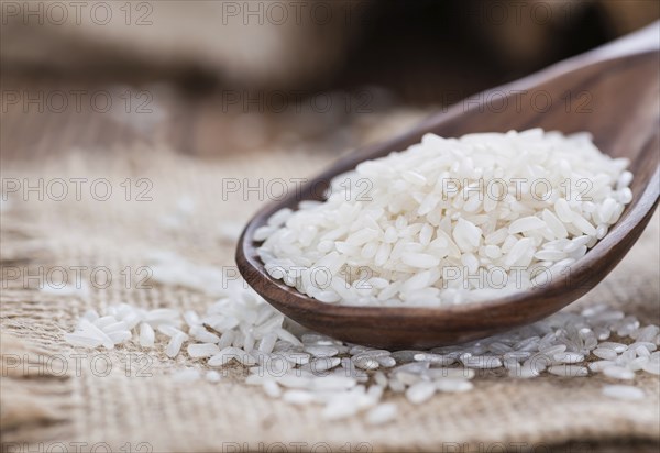 Portion of uncooked Rice on rustic wooden background