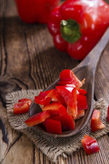 Sliced red Peppers (selective focus) on vintage wooden background