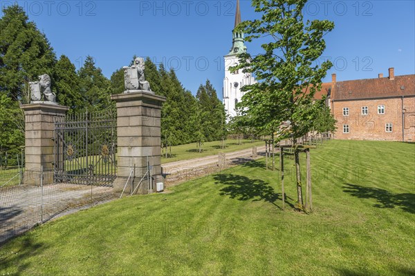 Brahetrolleborg church and castle, castle entrance, lawn, lions with coat of arms, Faborg, Faaborg,