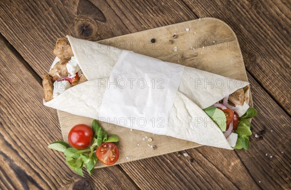 Homemade Chicken Wrap (close-up shot) on vintage background (selective focus)