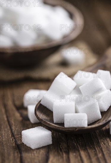 Old wooden table with white Sugar (selective focus, close-up shot)