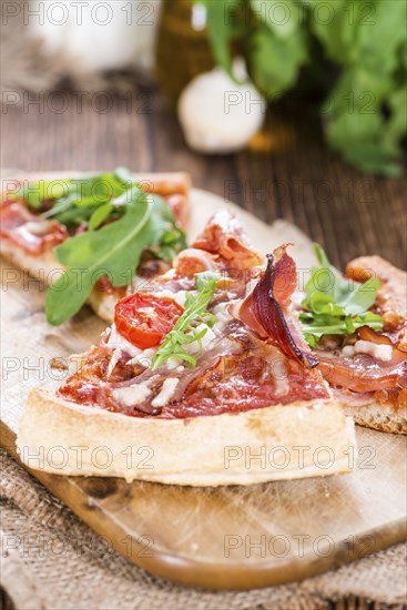 Ham Pizza with rocket, fresh tomatoes, garlic and cheese
