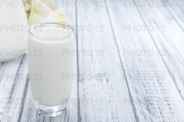 Portion of Milk on wooden background (close-up shot)