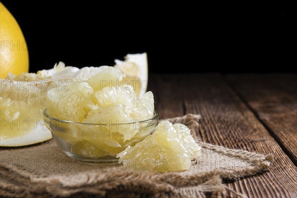 Fresh pieces of Pomelo (close-up shot) on vintage background