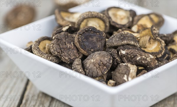 Dried Shiitake on a vintage background as detailed close-up shot, selective focus