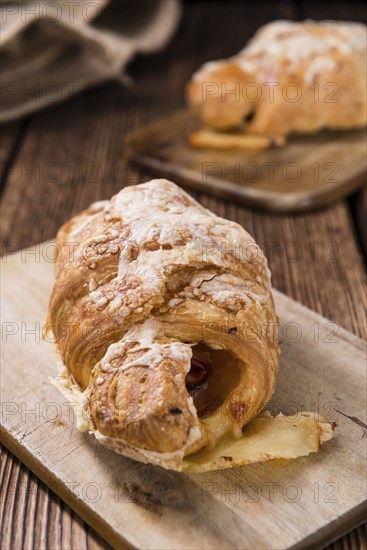 Homemade Ham and Cheese Croissant (selective focus) on wooden background