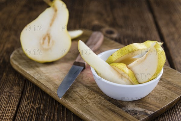 Pears (selective focus) on an old wooden table (close-up shot)