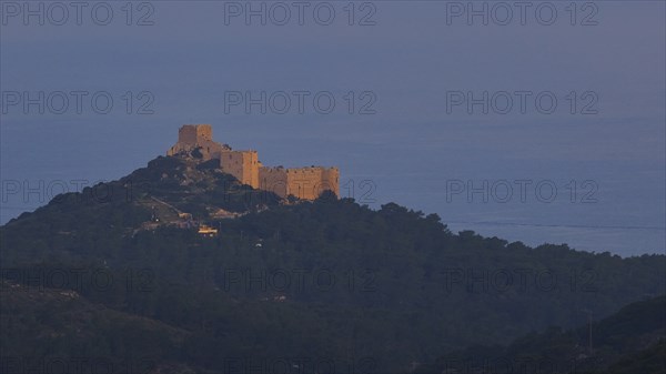 A castle on a hill in the first morning light, surrounded by natural landscape, Kritinia Castle, St